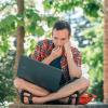 Student working on laptop outside