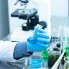 Stock image of a lab worker holding a flask