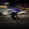 person riding bike at night with no lights
