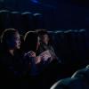 Three people in a movie theater.