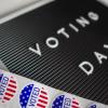 A voting day sign and stickers