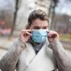 person wearing mask at an outdoor playground