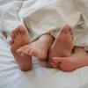 Bare feet sticking out from a blanket