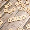 Scrabble pieces spelling "trade."