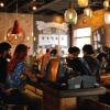 Diners and servers in a restaurant.
