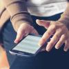 Woman checks bank account on smartphone