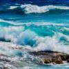 Photo of waves crashing in the ocean.