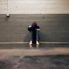 A person with head in hands, looking sad