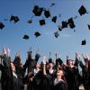 Graduates toss their caps in the air