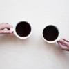 two people having a conversation over coffee