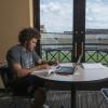 Student-athlete Philip Lindsay studying in club overlooking Folsom Field