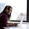 person wearing headphones at computer
