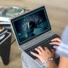 A person using Photoshop on a laptop