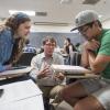 Instructor helps students in the classroom