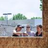 Students stand outside a pocket studio and talk. 