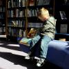 Child reads a book in the library