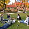 students sit in a circle outside on campus