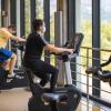 students in masks riding stationary bikes in The Rec