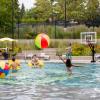 Students swimming in outdoor pool on campus