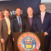 CU President Todd Saliman and Gov. Jared Polis, among others, at the quantum press conference