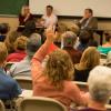 Woman raises hand during a CWA classroom visit