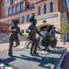 Sculpture depicting Ralphie and her handlers