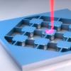 Artist's depiction of an electro-optic transducer, an ultra-thin wafer that can read out the information from a superconducting qubit.