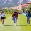 friends in masks walking on campus