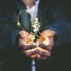 Person holding lightbulb with a string of LED lights