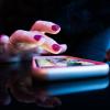 A hand hovers over a smart phone with apps. (Rob Hampson/Unsplash)