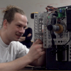 Senior Kenzy O'Neill makes an adjustment to his team's safecracking robot.