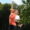 Student jumps in the air holding scholarship notification