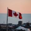 Canadian flag flying over a city