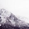 A stock image of mountains in the snow