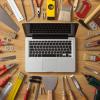 Stock image of a laptop computer surrounded by tools