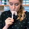 A researcher spits in a tube