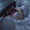 person sleeping in bed at night