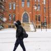 Student walks on snowy campus