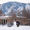 Students build a snowman on campus