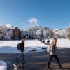 students walking across a snowy campus