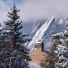 Top of a campus building with snowy Flatirons in the background