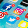 A photo showing social media apps on a phone screen