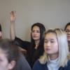 Student raises hand in classroom