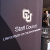 A Staff Council banner is on display at an employee fair outdoors.
