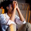 Person with hands covering face, stressed