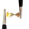 Two forceps twist an electronic device that's about the size of a BandAid