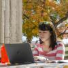 Student works on laptop computer outside