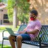 student working on laptop on campus