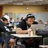 Students working on laptops on campus