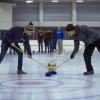 Students curling on the ice rink at The Rec